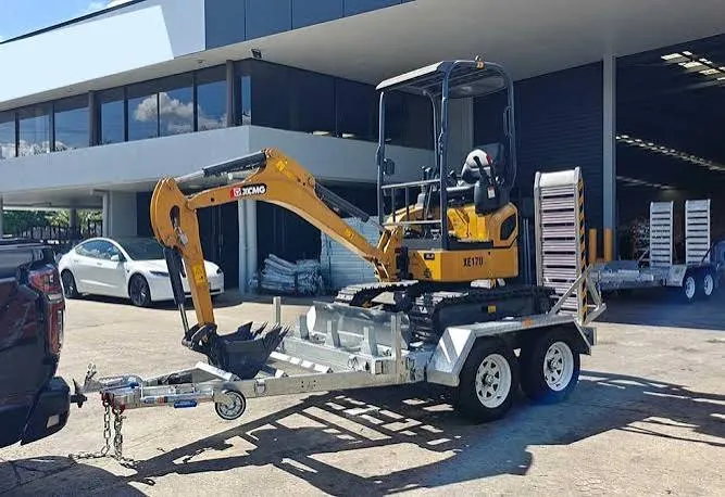 Mini excavator loaded on a galvanised tandem plant trailer